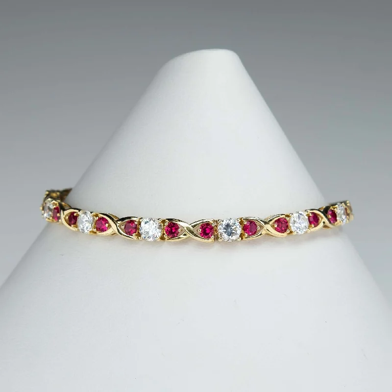 Ladies space gleam bracelets -Cubic Zirconia and Red Spinel "X"Link Tennis Bracelet is 14K Yellow Gold